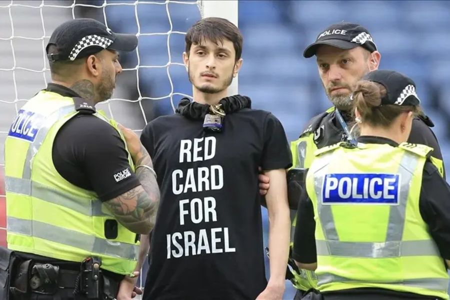 Protester chains himself to goalpost during Israel-Scotland football match